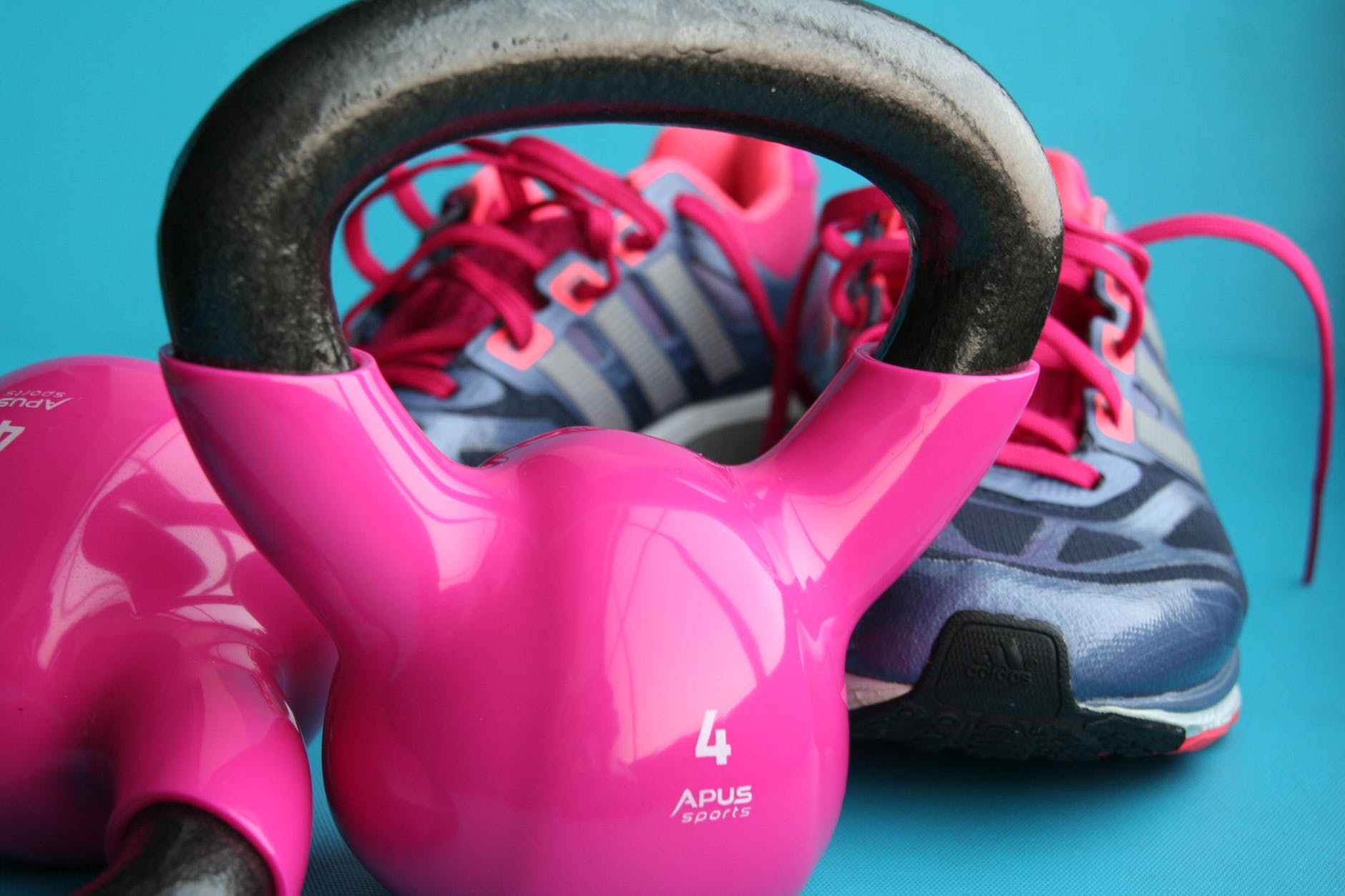 kettle bell beside adidas pair of shoes